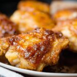 Close-up of golden brown, crispy air fryer chicken thighs, ready to be served.