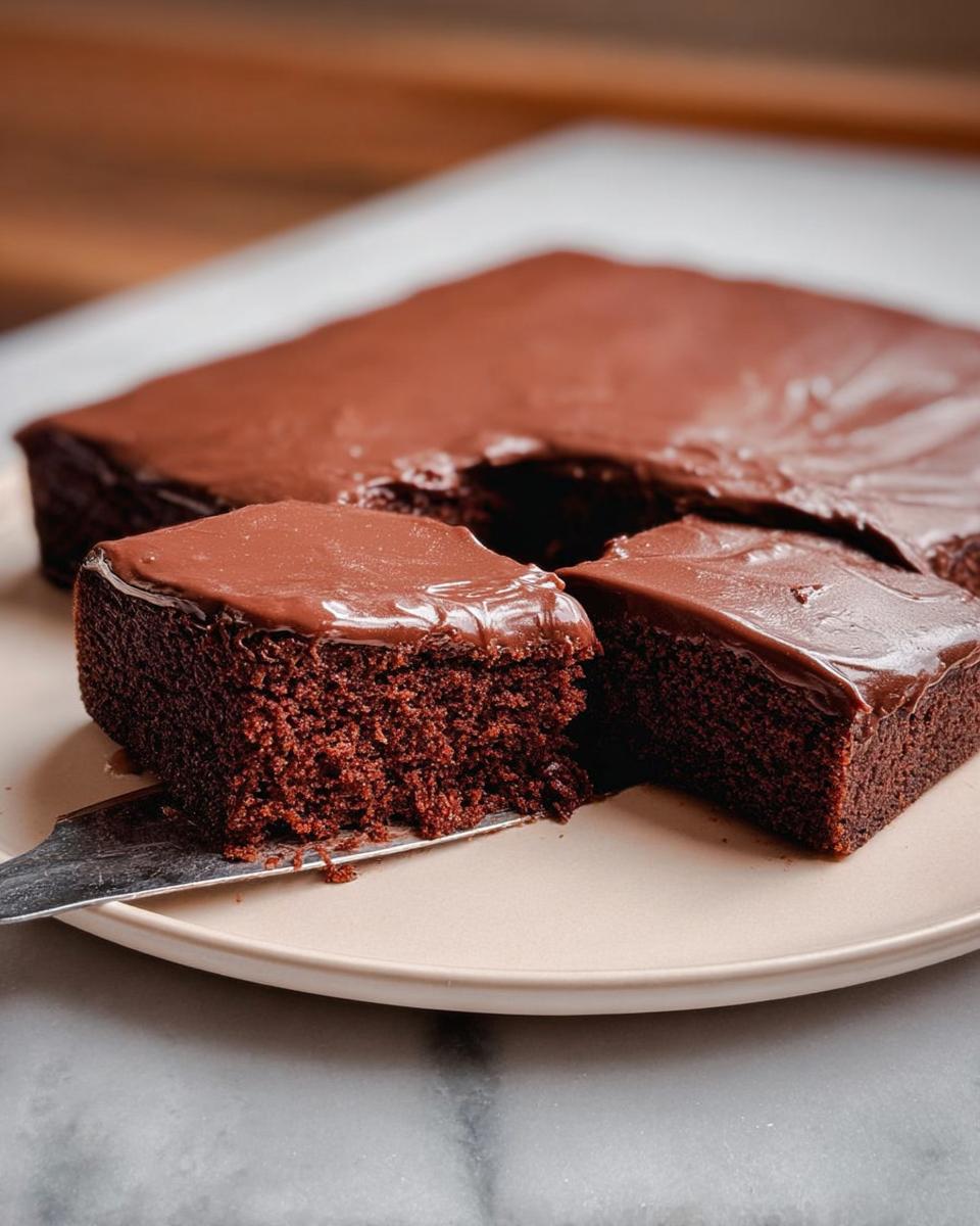 Close-up of rich chocolate cake ideas recipes, with a slice being served on a plate.