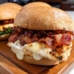 Close-up of a delicious restaurant-style chicken burger with melted cheese and crispy bacon, part of easy dinner recipes.