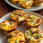 Close-up of baked egg muffins with vegetables and cheese, perfect for egg recipes meal prep.