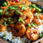 Close-up of Irresistible Honey Garlic Shrimp Bowls with rice and mixed vegetables, garnished with green onions.