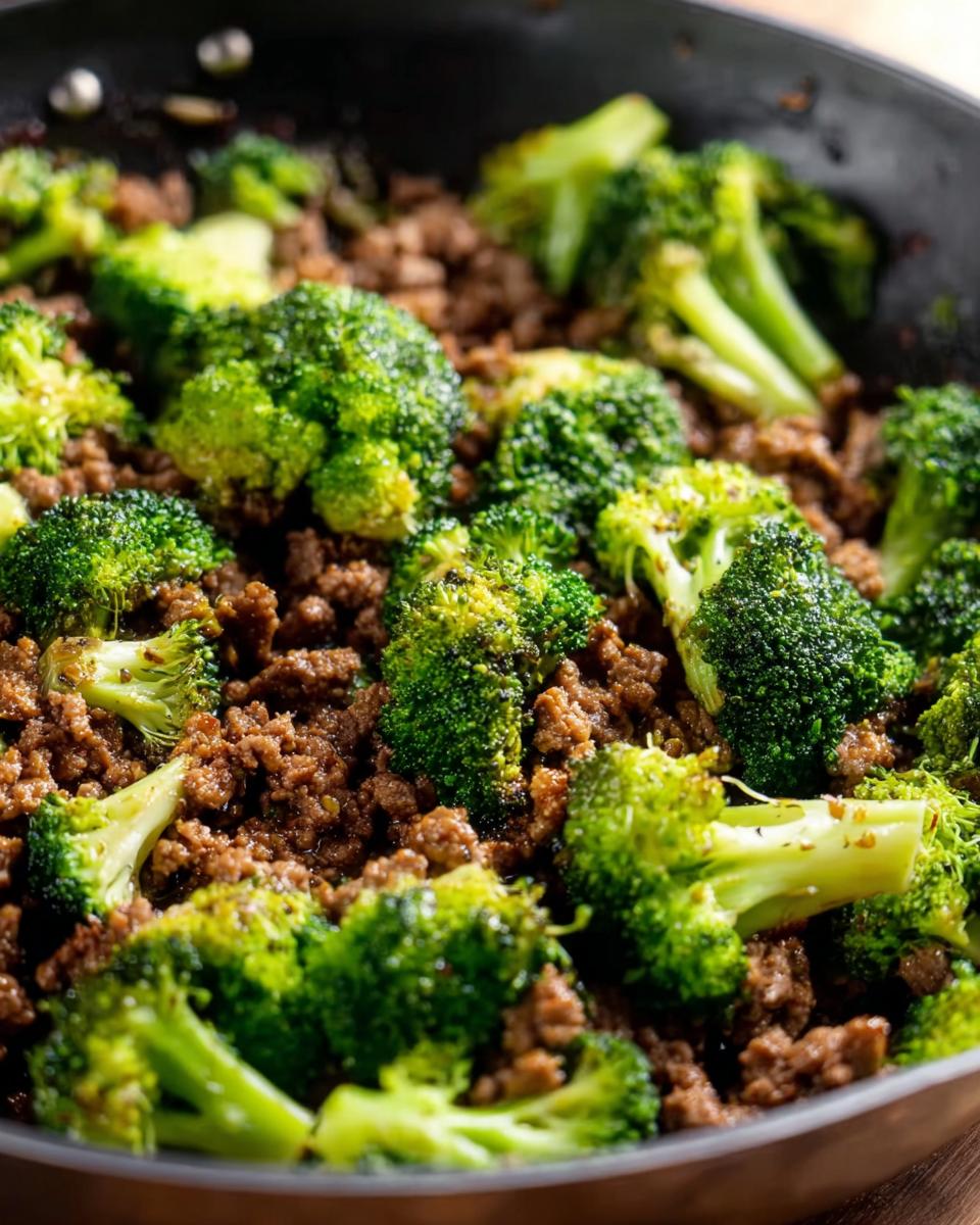 Close-up of a Keto Hamburger Broccoli Skillet in a pan, showing seasoned ground beef and bright green broccoli florets.