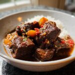 Close-up of tender chunks of Korean Style Pot Roast served with fluffy white rice and a rich, savory sauce.