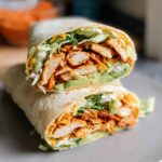 A delicious wrap filled with creamy spinach, eggs, chicken, avocado, and cheese.