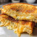 Close-up of a delicious Garlic Bread Grilled Cheese sandwich, with melted cheese oozing out.