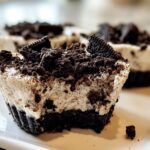 A close-up of a Healthy No-Bake Oreo Cheesecake Bite, showing the creamy filling and crushed Oreo topping.