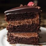 A rich slice of Dark Chocolate Mousse Cake with layers of moist chocolate cake and creamy chocolate mousse.