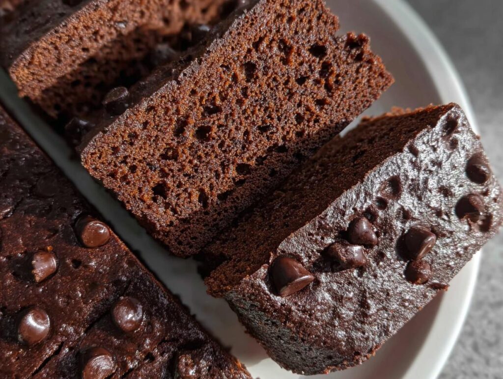 Close-up of moist Greek Yogurt Brownies slices topped with melted chocolate chips.
