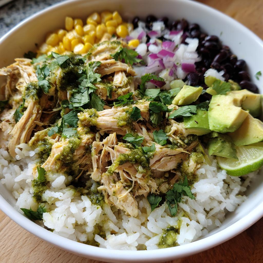 A delicious Slow Cooker Salsa Verde Chicken Taco Bowl with rice, chicken, black beans, corn, avocado, and cilantro.